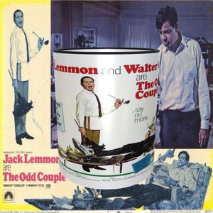 May include: A white ceramic coffee mug with a black rim. The mug features a black and white image of Jack Lemmon and Walter Matthau from the movie "The Odd Couple". The text "Lemmon and Walter are The Odd Couple...say no more" is printed on the mug.