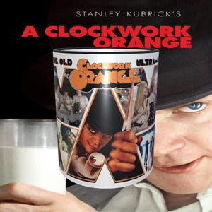 May include: A white ceramic mug with a black rim features a collage of images from the movie "A Clockwork Orange". The mug has a black and white image of Alex DeLarge in the center, with other scenes from the film surrounding him. The text "A Clockwork Orange" is printed in orange and black at the top of the mug.