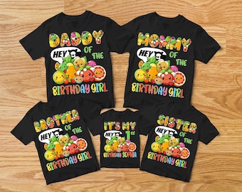 May include: Set of five black t-shirts with colorful fruit and the text "Daddy of the Birthday Girl", "Mommy of the Birthday Girl", "Brother of the Birthday Girl", "Sister of the Birthday Girl", and "It's My 1st Birthday Sophia".