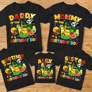 May include: Black t-shirts with colorful text and fruit graphics. The shirts read "Daddy of the Birthday Boy", "Mommy of the Birthday Boy", "Brother of the Birthday Boy", "Alex 6 Birthday Boy", and "Sister of the Birthday Boy".