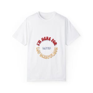 May include: White t-shirt with a red and orange circle graphic that says "I'm here for Katie Lou Samuelson".