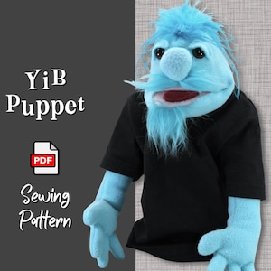 May include: A blue puppet wearing a black t-shirt. The puppet has a large nose and a long beard. The text "YiB Puppet" and "Sewing Pattern" is written on the image. The text "PDF" is written on a white icon.