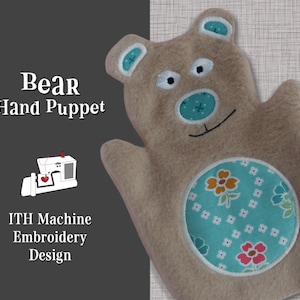May include: A brown felt hand puppet in the shape of a bear. The bear has a blue nose, black eyes, and a white mouth. The bear's belly is decorated with a blue and white floral pattern. The text "Bear Hand Puppet" and "ITH Machine Embroidery Design" is visible on the image.