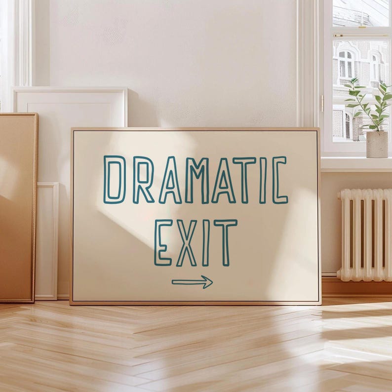 May include: A beige framed sign with the text "DRAMATIC EXIT" in teal blue outlined letters with an arrow pointing to the right.
