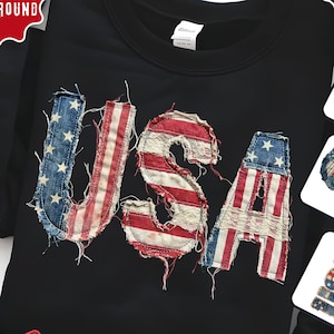 May include: Black crew neck sweatshirt featuring the word "USA" in a distressed design using red, white, and blue fabric, resembling the American flag. The design has a patriotic theme.