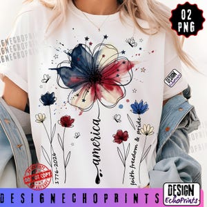 K&ouml;nnte beinhalten: Wei&szlig;es T-Shirt mit einem floralen Design in Rot, Wei&szlig; und Blau. Der Schriftzug "america" ist in Schreibschrift gehalten, erg&auml;nzt durch die Texte "faith freedom & pride" und "1776-2026". Das Design beinhaltet Schmetterlinge und Sterne.