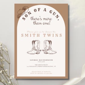 May include: A tan and white baby shower invitation with a cowboy boot design. The text reads "Son of a Gun, there's more than one!" and "Please join us to shower the Smith Twins".