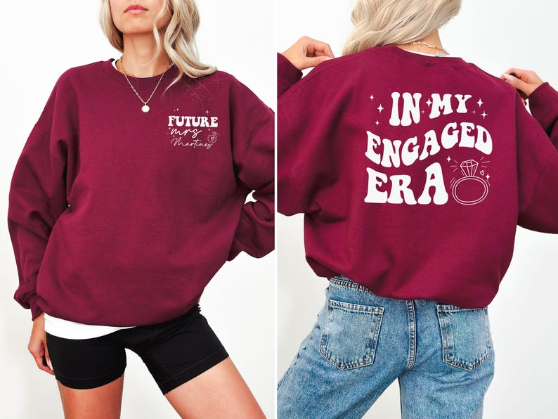 May include: Burgundy sweatshirt with white text that says "Future Mrs. Martinez" on the front and "In My Engaged Era" with a diamond ring on the back.