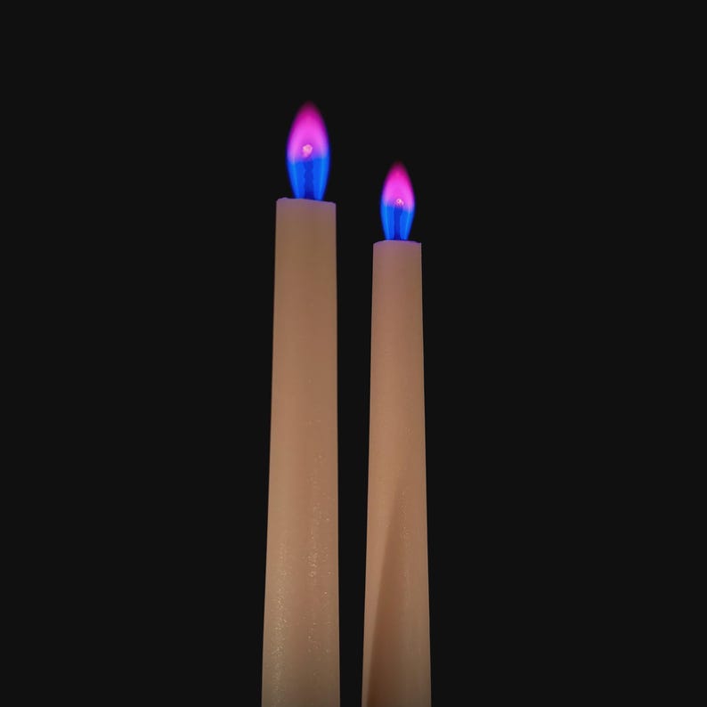 Close-up of romantic pink flame candles producing vivid pink flames, handmade for science fans, witches, and love manifestation.