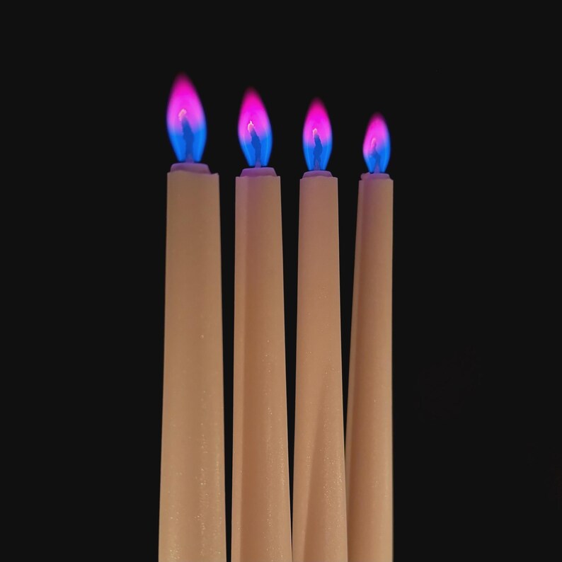 Close-up of romantic pink flame candles producing vivid pink flames, handmade for science fans, witches, and love manifestation.