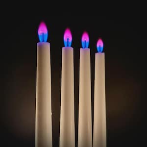 Close-up of romantic pink flame candles producing vivid pink flames, handmade for science fans, witches, and love manifestation.