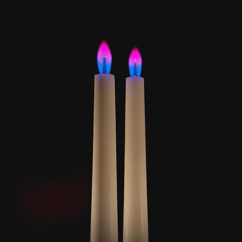 Close-up of romantic pink flame candles producing vivid pink flames, handmade for science fans, witches, and love manifestation.