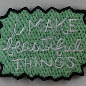 May include: Green embroidered patch with white text that reads "I MAKE beautiful THINGS".