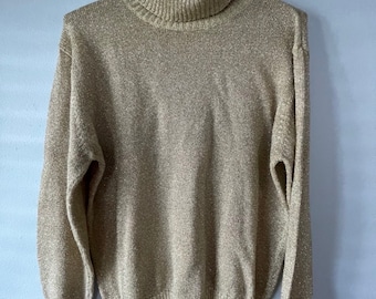 May include: A gold sparkly turtleneck sweater with long sleeves and a ribbed collar and cuffs.