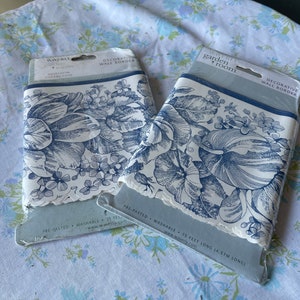 May include: Two rolls of pre-pasted, washable wallpaper border featuring a blue and white floral pattern. The border is 15 feet long and is part of the Waverly Garden Room Heirloom Collection.