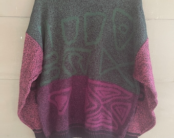 May include: A multi-colored knit sweater with a geometric pattern and the word "METRO" written in green on the front.