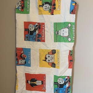 May include: A white cotton pillowcase with a colorful print of Thomas the Tank Engine characters. The characters include Thomas, Percy, Gordon, Harold, Bertie, Terence, and Sir Topham Hatt.