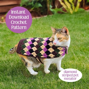 May include: A cat wearing a diamond-patterned crochet pet sweater in brown, purple, black, and tan. The image includes text that reads "Instant Download Crochet Pattern" and "diamond striped pet sweater". The cat is on green grass.