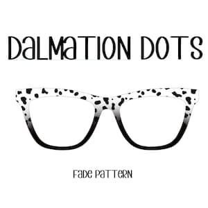 May include: Cat-eye style eyeglasses with a white frame featuring black dalmatian spots. The lenses fade to black at the bottom. The text "DALMATION DOTS" is above the glasses, and "FADE PATTERN" is below.