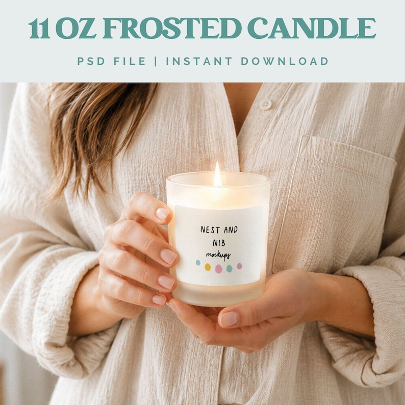 May include: A frosted glass candle with a lit wick is held in front of a person. The candle has a label that reads "NEST AND NIB mockups" with colorful dots. The text "11 OZ FROSTED CANDLE" and "PSD FILE | INSTANT DOWNLOAD" are at the top.