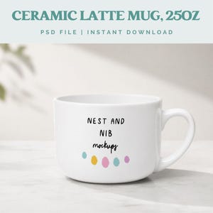 May include: White ceramic latte mug with the text "NEST AND NIB mockups" and colorful dots. The mug is labeled "CERAMIC LATTE MUG, 25OZ" at the top. The mug has a curved handle and is on a light-colored surface.