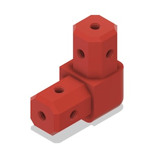 May include: A red, right-angle connector with a hexagonal shape on each end. Each end has a central hole and smaller holes on the sides. The connector is designed for joining components at a 90-degree angle.