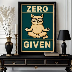 May include: A framed poster with the words "ZERO GIVEN" and a cartoon cat wearing glasses in a yoga pose. The poster is on a black table with a black lamp, a vase, and a candle holder.