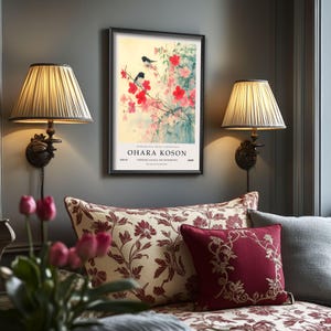 May include: A framed print of a Japanese painting featuring two black birds perched on a branch of a flowering tree with pink and red blossoms. The print is titled "Ohara Koson" and is from the "Woodblock Print Exhibition" at the "Shiseido Gallery Art Movements".