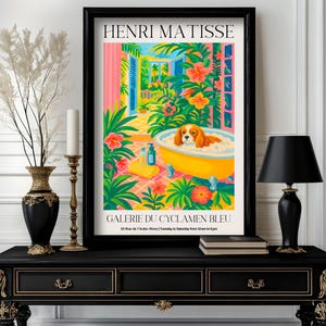 May include: A framed art print featuring a colorful illustration by Henri Matisse. The artwork depicts a dog in a yellow bathtub surrounded by lush greenery and flowers. The text "GALERIE DU CYCLAMEN BLEU" is visible.