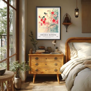 May include: A framed print of a Japanese painting featuring a branch of pink blossoms with two black birds perched on the branches. The print is titled "Ohara Koson" and is from the "Birds and Flowers" collection.