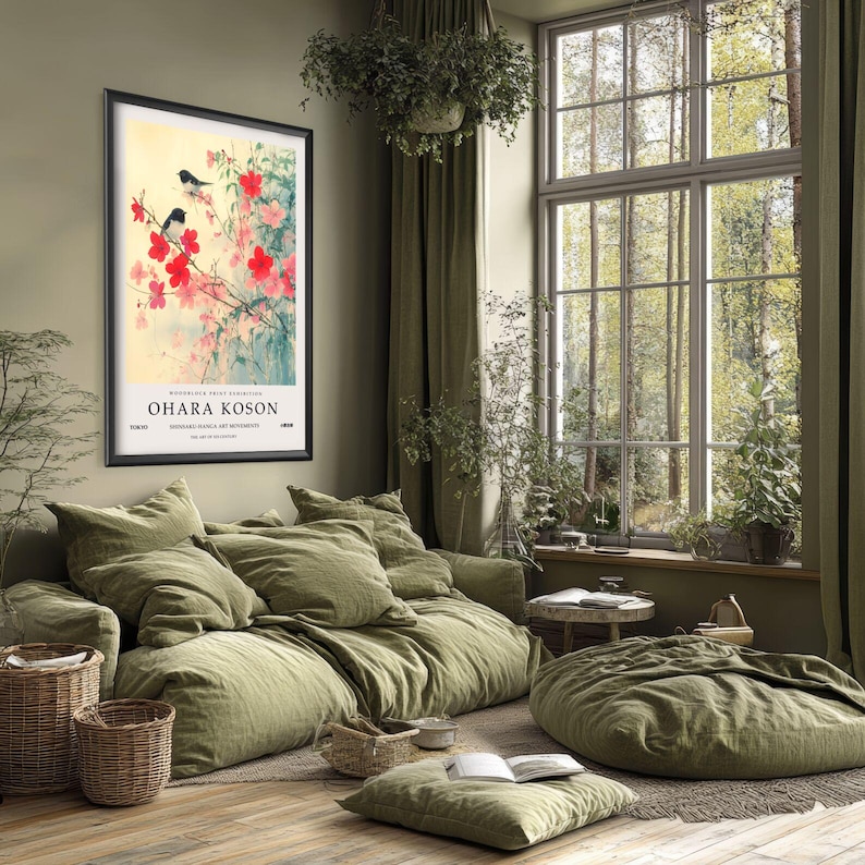 May include: A framed print of a Japanese painting featuring two black birds perched on a branch of pink blossoms. The print is titled "Ohara Koson" and is displayed on a wall in a living room setting.