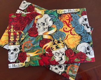 May include: A set of three fabric panels with a skull and rose motif. The panels feature a red, yellow, green, and blue color scheme. The text "Carpe Noctem" is printed on one of the panels.
