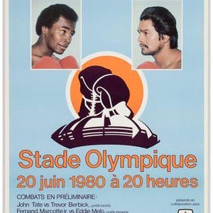 May include: Vintage boxing poster featuring Sugar Ray Leonard and Roberto Duran. The poster has a light blue background with portraits of the boxers and boxing gloves. Text includes "Stade Olympique" and event details.