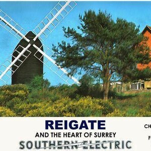 May include: Vintage travel poster featuring a black windmill with white blades against a blue sky. A red-brick house and green trees are in the background. The poster promotes Reigate and the Heart of Surrey, with text about rail travel.