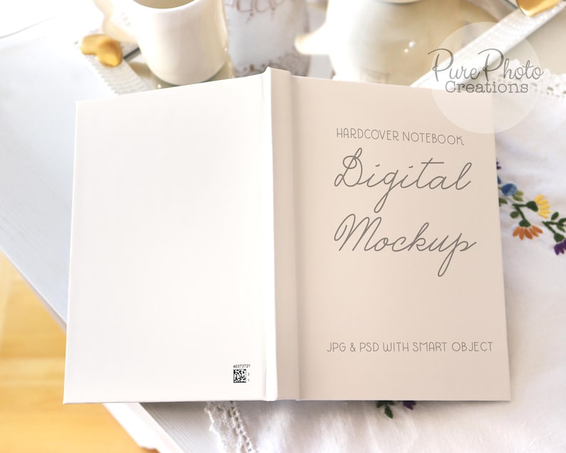 May include: A white hardcover notebook mockup with the text "HARDCOVER NOTEBOOK Digital Mockup JPG & PSD WITH SMART OBJECT" on the front cover.
