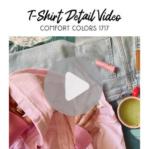 May include: A pink t-shirt with a pink long-sleeve shirt underneath, next to a pair of light blue jeans. The image also includes a pink lipstick, a red object, and a cup of green liquid. Text on the image reads "T-Shirt Detail Video" and "Comfort Colors 1717".