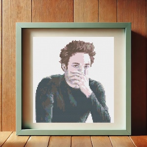 May include: A cross-stitch portrait of a person with brown hair wearing a dark green turtleneck sweater. The person is looking down and covering their mouth with their hand.