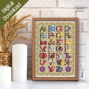 May include: A framed cross-stitch alphabet sampler with a beige background and a brown wooden frame. Each letter is accompanied by a colorful, themed image. The words "Digital Download" are in the upper left corner.