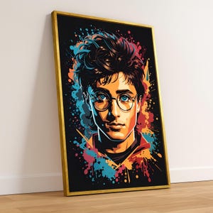 May include: A framed art print featuring a stylized portrait of a young man with glasses. The artwork uses a vibrant color palette with splashes of blue, orange, and red against a black background. The frame is gold.