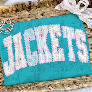 May include: A set of three ceramic mugs with a speckled, cream-coloured glaze. Each mug features a different hand-painted floral design in shades of blue, green, and yellow. The mugs have a simple, modern shape.