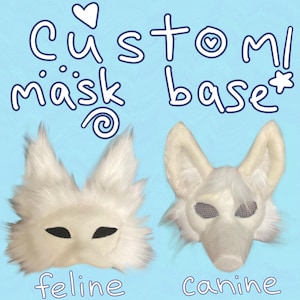 May include: Two white faux fur mask bases on a light blue background. The left mask is a feline design with pointed ears and almond-shaped eyes. The right mask is a canine design with upright ears and mesh eye coverings. Text reads Custom mask base.