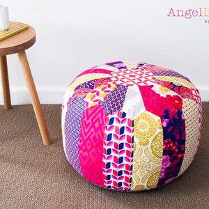 May include: A round, multi-colored patchwork ottoman with a variety of floral and geometric patterns in pink, yellow, white, blue, and purple.