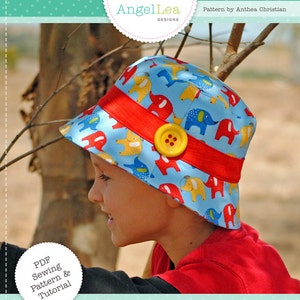 May include: A PDF sewing pattern and tutorial for a blue and yellow hat with an elephant print. The hat is called "Scout" and is designed by AngelLea Designs.