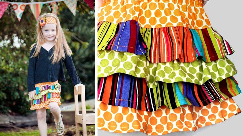 May include: A multi-layered skirt with a bright, colourful pattern. The skirt features a top layer of orange fabric with white polka dots, followed by layers of green polka dots, striped fabric, and more polka dots. The skirt is a fun and playful piece of clothing.