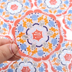 May include: A set of colorful stickers featuring a mandala design with a cell-like pattern. The stickers are printed on clear vinyl and have a glossy finish.