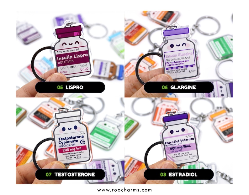 May include: Keychains featuring cartoon-style medicine bottles with labels for Lispro, Glargine, Testosterone, and Estradiol. Each keychain has a black ring and a smiling face design. The text on the bottles includes medication names and dosages.