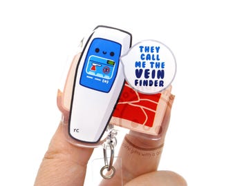 May include: A white and blue acrylic badge reel featuring a cartoon vein finder device with a smiling face. A speech bubble attached to the side displays the blue text: THEY CALL ME THE VEIN FINDER. The design includes a red background element.