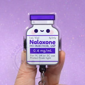 May include: A badge reel shaped like a 1 mL Naloxone vial with a purple cap and a white label featuring a smiling face. The text reads 1mL Vial, Rx Only, Naloxone HCI INJECTION, USP, 0.4 mg/mL, and For IV, IM or SC use Protect from light.