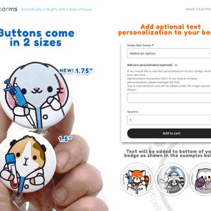 a hand holding two buttons with a dog and cat on them