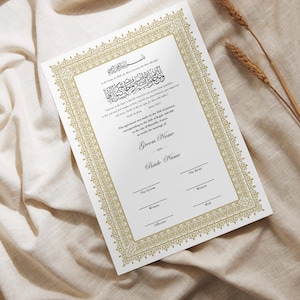 May include: A wedding certificate with gold decorative borders and Arabic calligraphy. The document has spaces for the groom's and bride's names, witnesses, and officiant. The words "Wali, Witnesses and Officiant" are at the top.